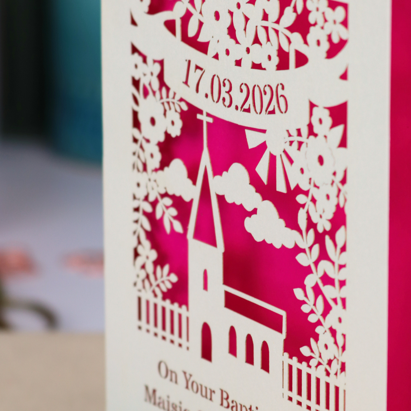 A laser cut Baptism card with floral cut out church design, a banner with cut out date in stencil font and text "On your Baptism Day, Maisie Charlotte Parsons"