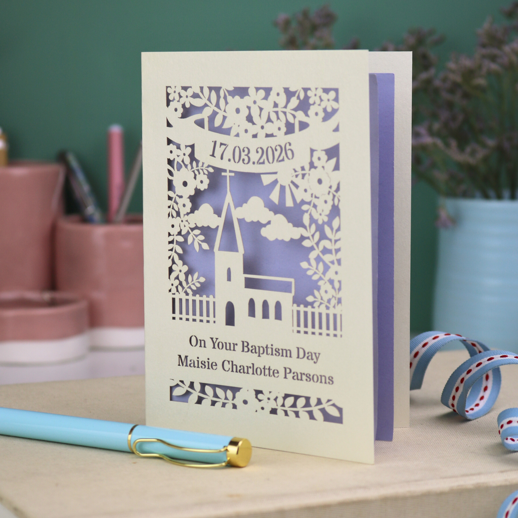 A laser cut Baptism card with floral cut out church design, a banner with cut out date in stencil font and text "On your Baptism Day, Maisie Charlotte Parsons"