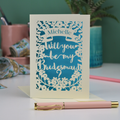 Laser cut Card with 'Will you be my Bridesmaid?' text on a desk with stationery items.