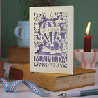 Decorative card with 'Bon Voyage Mathilda' design on a book with a candle and ribbon in the background.