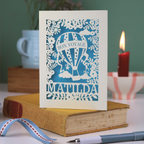 Card with 'Bon Voyage Matilda' design on a book with a candle and ribbon in the background