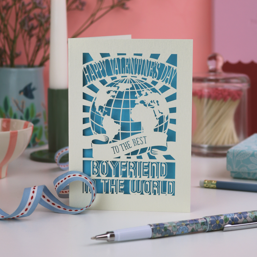 Boyfriend Valentine's Card with blue design and text on a table with stationery items