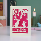 Birthday Card with cut-out designs of  bunny rabbits and decorative elements on a pink background, with 'Callie' written below.