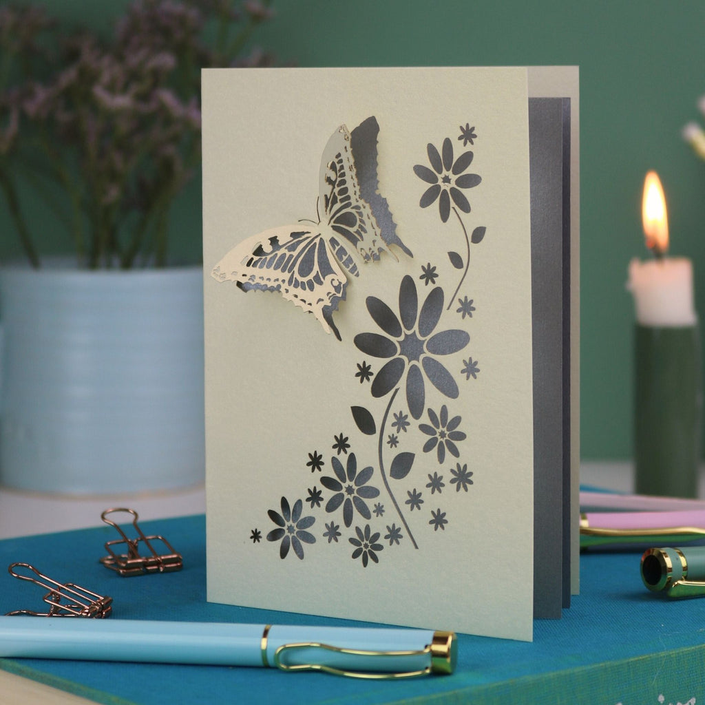 a laser cut 3D butterfly card with silver paper insert