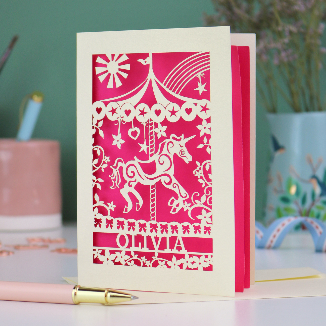 A laser cut girls birthday card with carousel design and personalised with a name. 