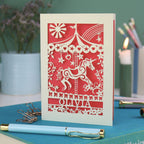 A laser cut carousel card with vintage fairground horse design and personalised with the name Olivia at the bottom