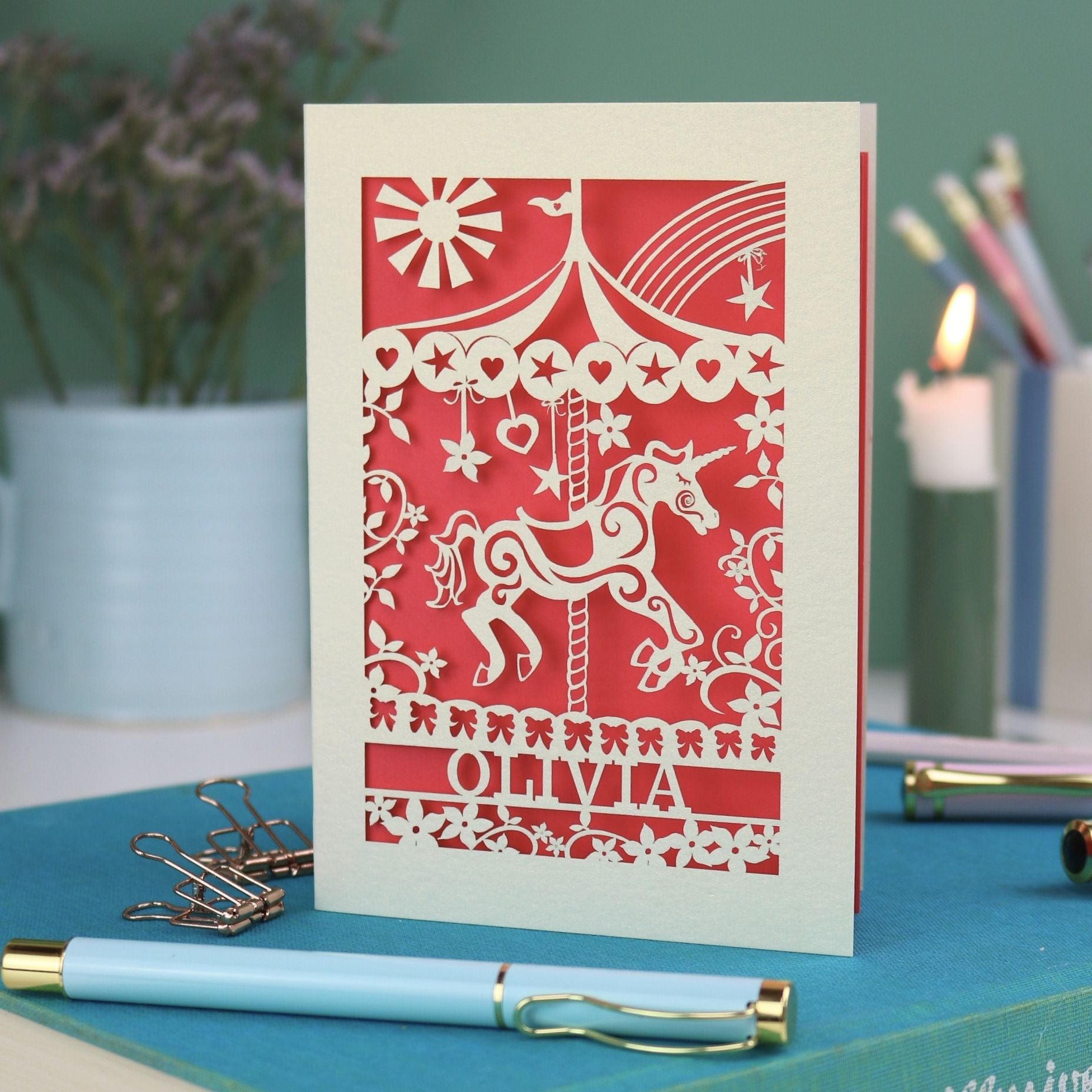 A laser cut carousel card with vintage fairground horse design and personalised with the name Olivia at the bottom