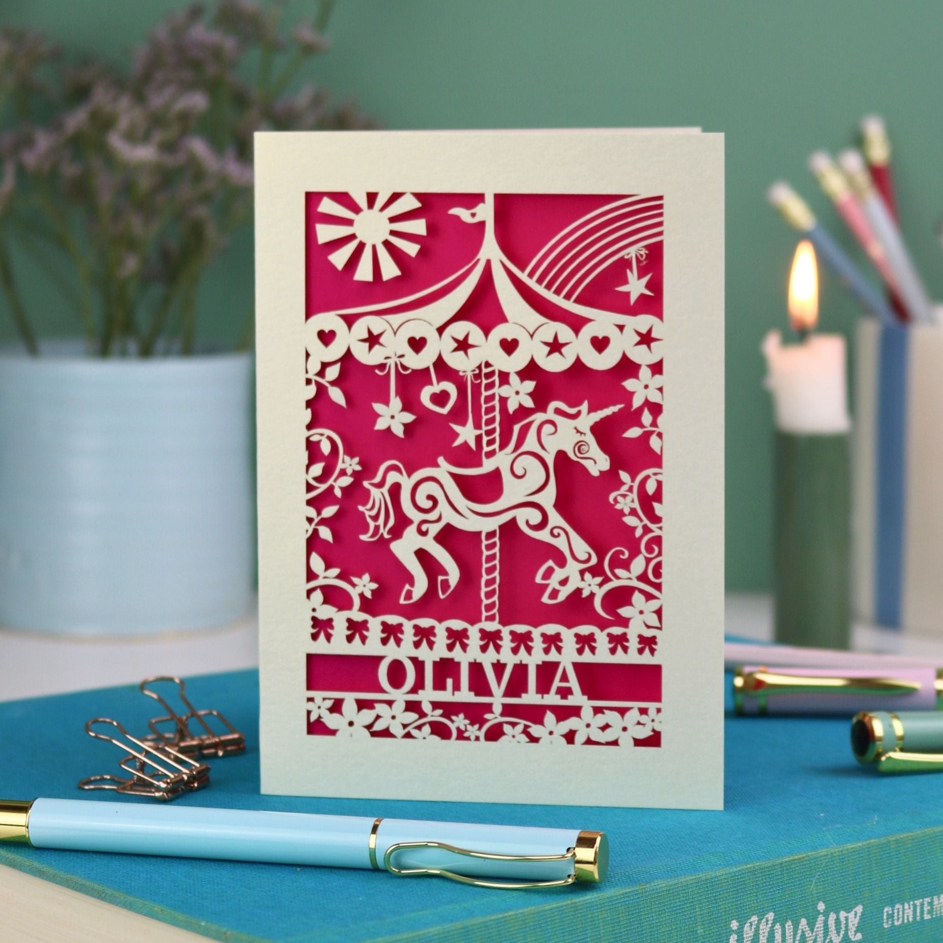 A laser cut carousel card with vintage fairground horse design and personalised with the name Olivia at the bottom