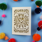 Laser cut Card with 'Thinking Of You This Christmas' text on a blue background 