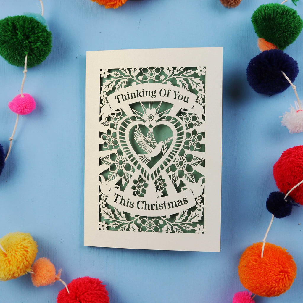 Laser cut Card with 'Thinking Of You This Christmas' text on a blue background 