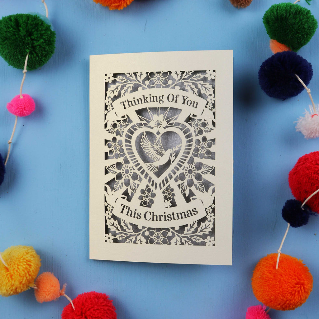 Laser cut Card with 'Thinking Of You This Christmas' text on a blue background 