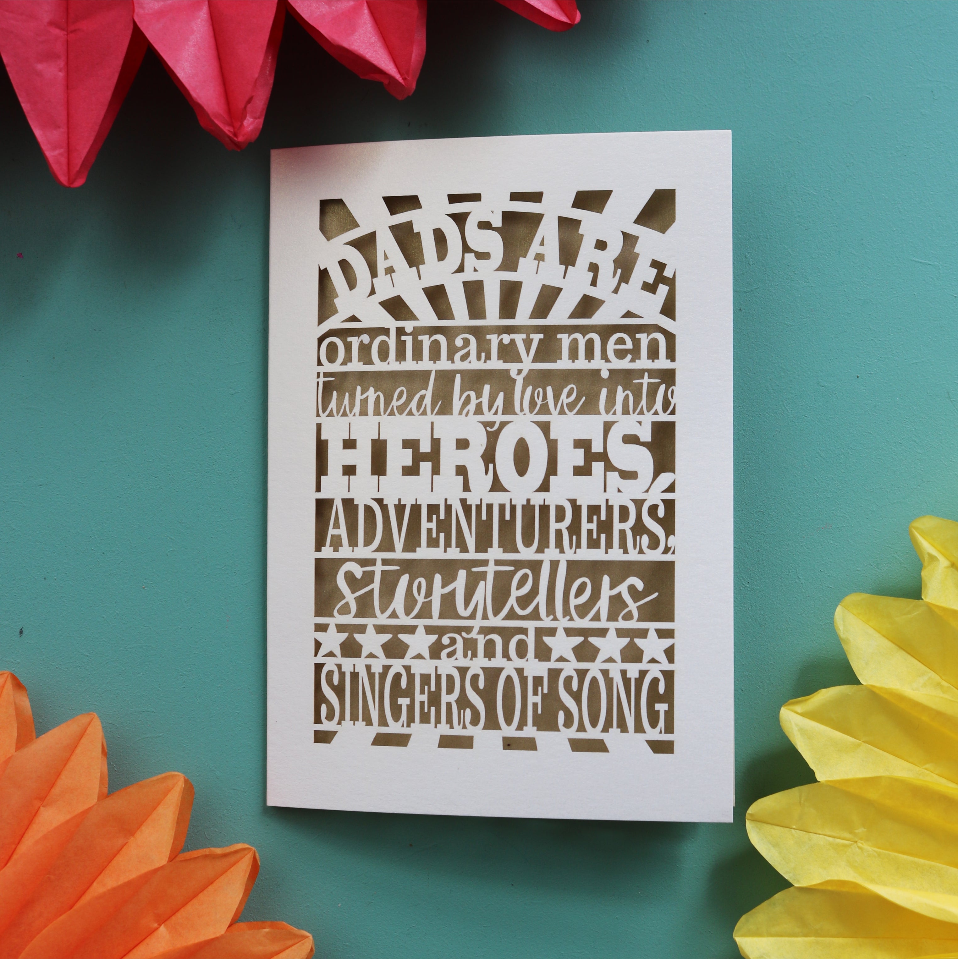 A meaningful father's day card laser cut with the words "dads are ordinary men turned by love into heroes, adventurers, storytellers and singers of song"