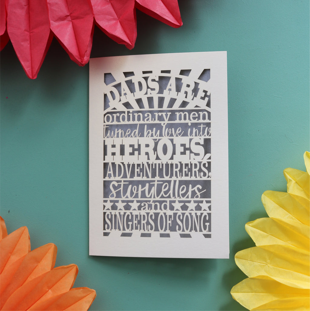 Unique father's day card laser cut with the words "dads are ordinary men turned by love into heroes, adventurers, storytellers and singers of song"