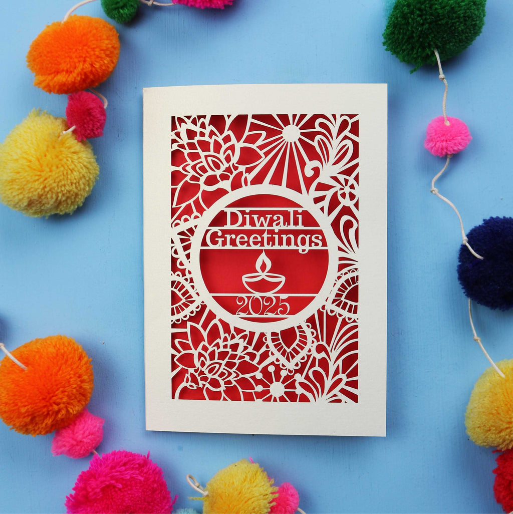 Paper Cut Diwali card with decorative elements on a blue background