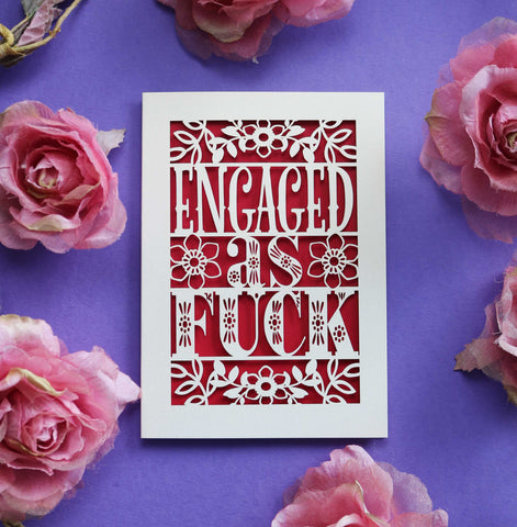 A laser cut engagement card that says "Engaged as fuck"