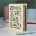 Greeting card with flamingo design and 'Completely Fabulous Mum' text on a desk with stationery items.