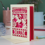 Greeting card with flamingo design and 'Completely Fabulous Mum' text on a desk with stationery items.