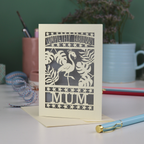Greeting card with flamingo design and 'Completely Fabulous Mum' text on a desk with stationery items.