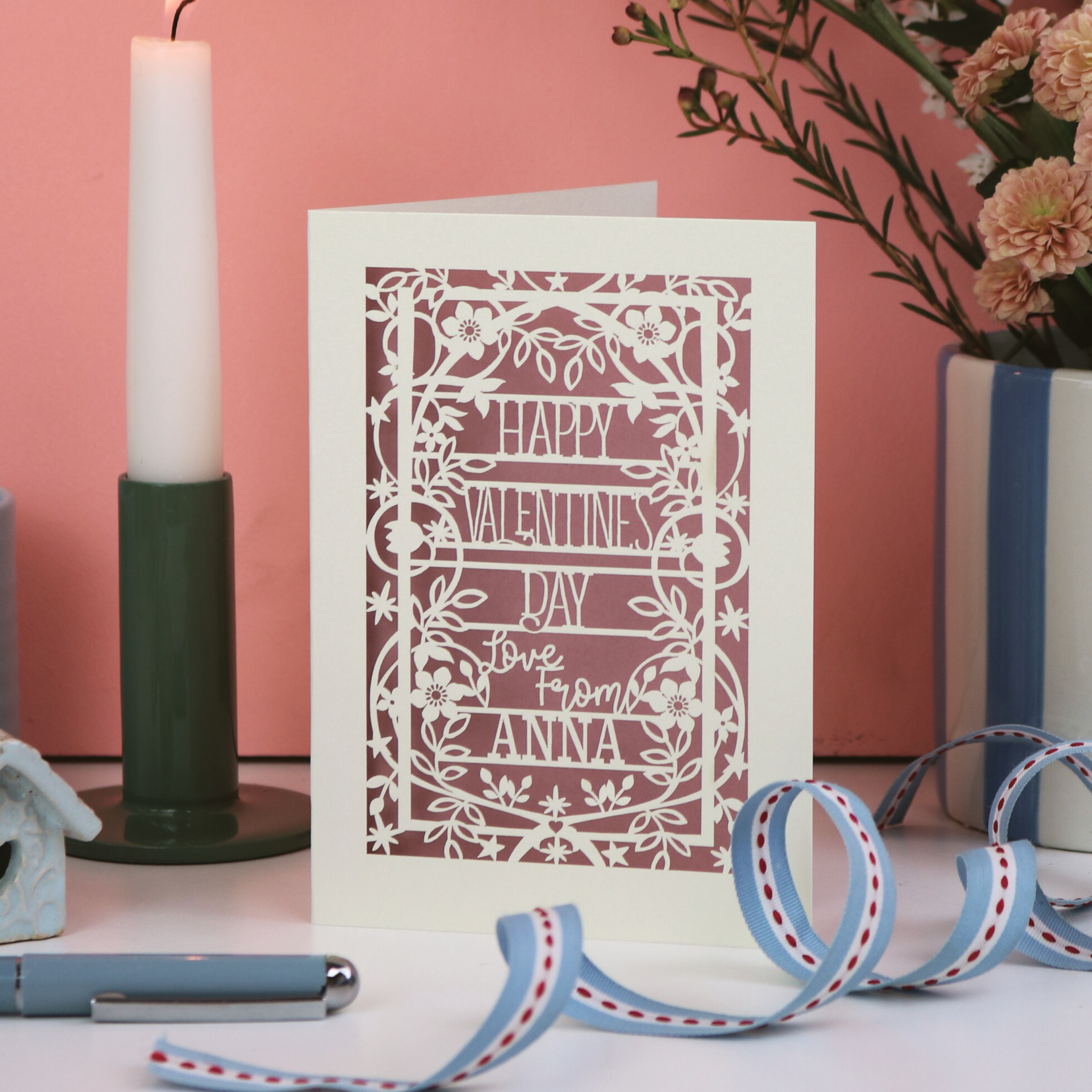 Valentine's Day card with decorative elements on a pink background