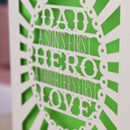A laser cut sentimental Father's Day card with the cut out quote "Dad, a son's first hero, a daughter's first love"