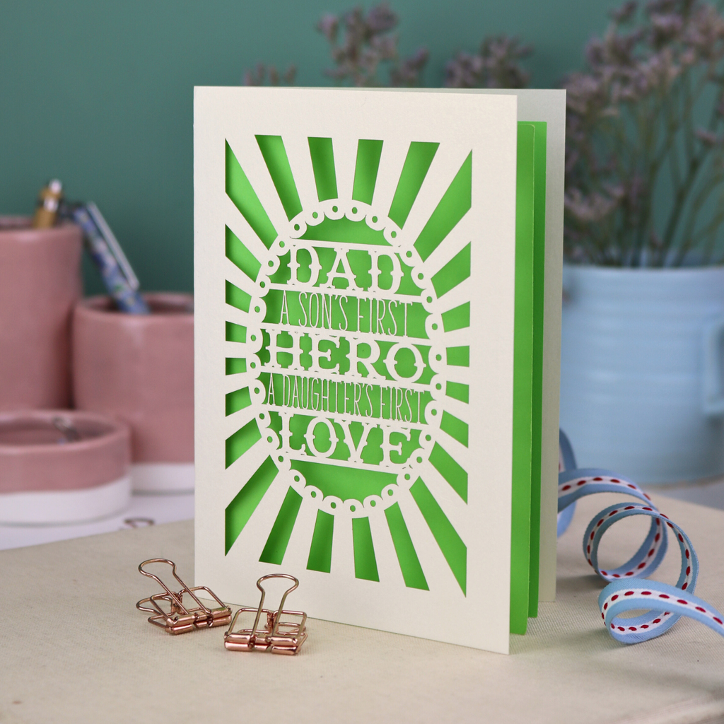A laser cut sentimental Father's Day card with the cut out quote "Dad, a son's first hero, a daughter's first love"