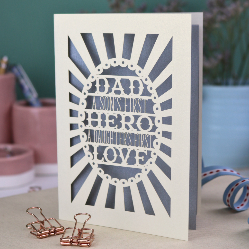 A laser cut sentimental Father's Day card with the cut out quote "Dad, a son's first hero, a daughter's first love"