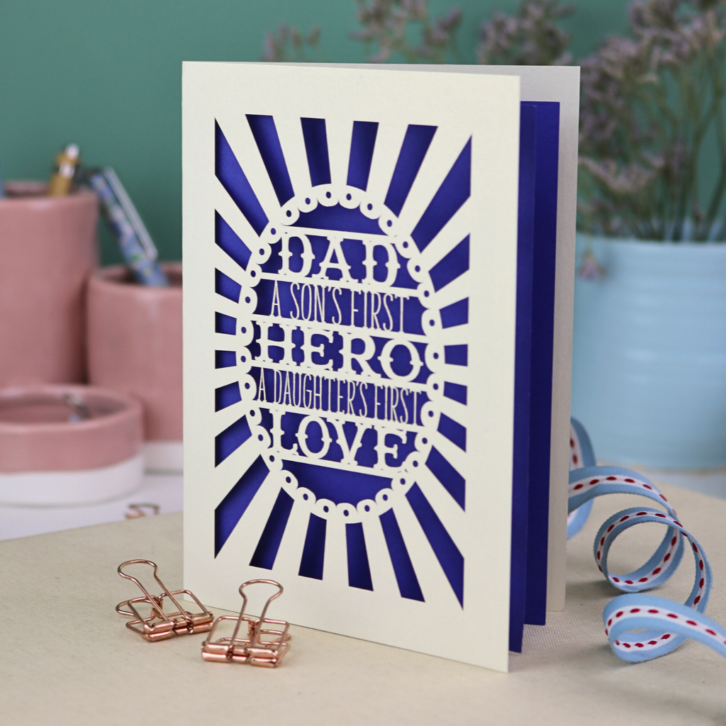 A laser cut sentimental Father's Day card with the cut out quote "Dad, a son's first hero, a daughter's first love"