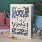 A cream laser cut personalised Father's Day card with mountain design and the text "Daddy" in a banner at the top, and "You keep me safe and I'll keep you wild" underneath