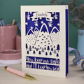 A cream laser cut personalised Father's Day card with mountain design and the text "Daddy" in a banner at the top, and "You keep me safe and I'll keep you wild" underneath