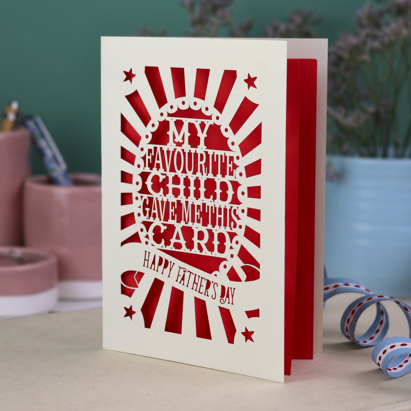 A laser cut funny Father's Day card with the cut out text, "My favourite child gave me this card. Happy Father's Day"