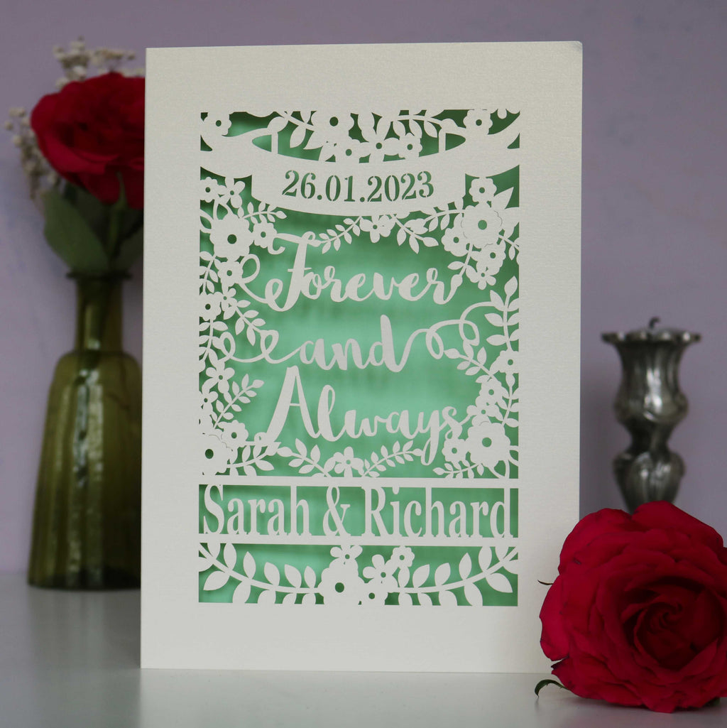 Laser cut wedding cards that say Forever and Always, and is personalised with a date and the names of the couple.