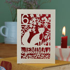 A laser cut birthday card with woodland scene and fox cut out design, personalised with an age in the top left, and a name at the bottom. 