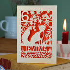 A laser cut birthday card with woodland scene and fox cut out design, personalised with an age in the top left, and a name at the bottom. 