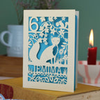A laser cut birthday card with woodland scene and fox cut out design, personalised with an age in the top left, and a name at the bottom. 