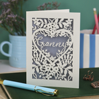 Laser cut Card with floral design and 'Granny' text on a desk with stationery items.