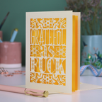 A funny, rude thank you card with sweary text, "Grateful As Fuck", surrounded by floral cut out design, in cream with a yellow paper insert