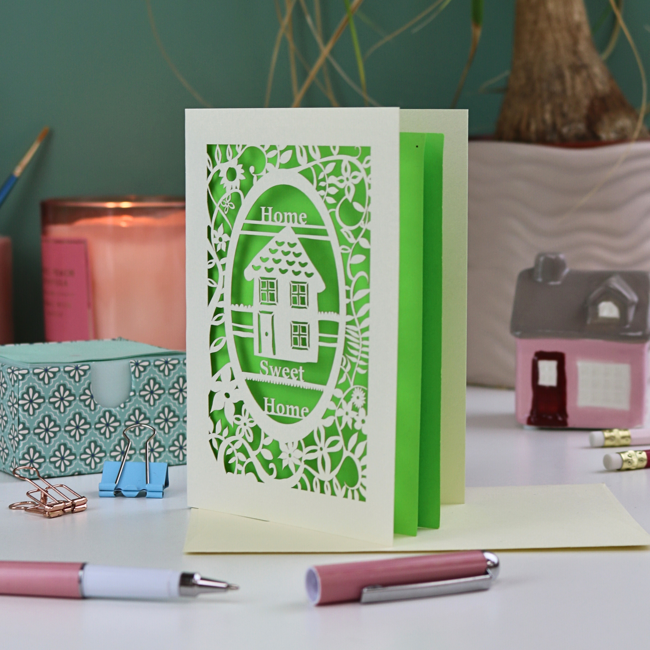 A laser cut new home card with floral border, house design and the words "Home sweet home"