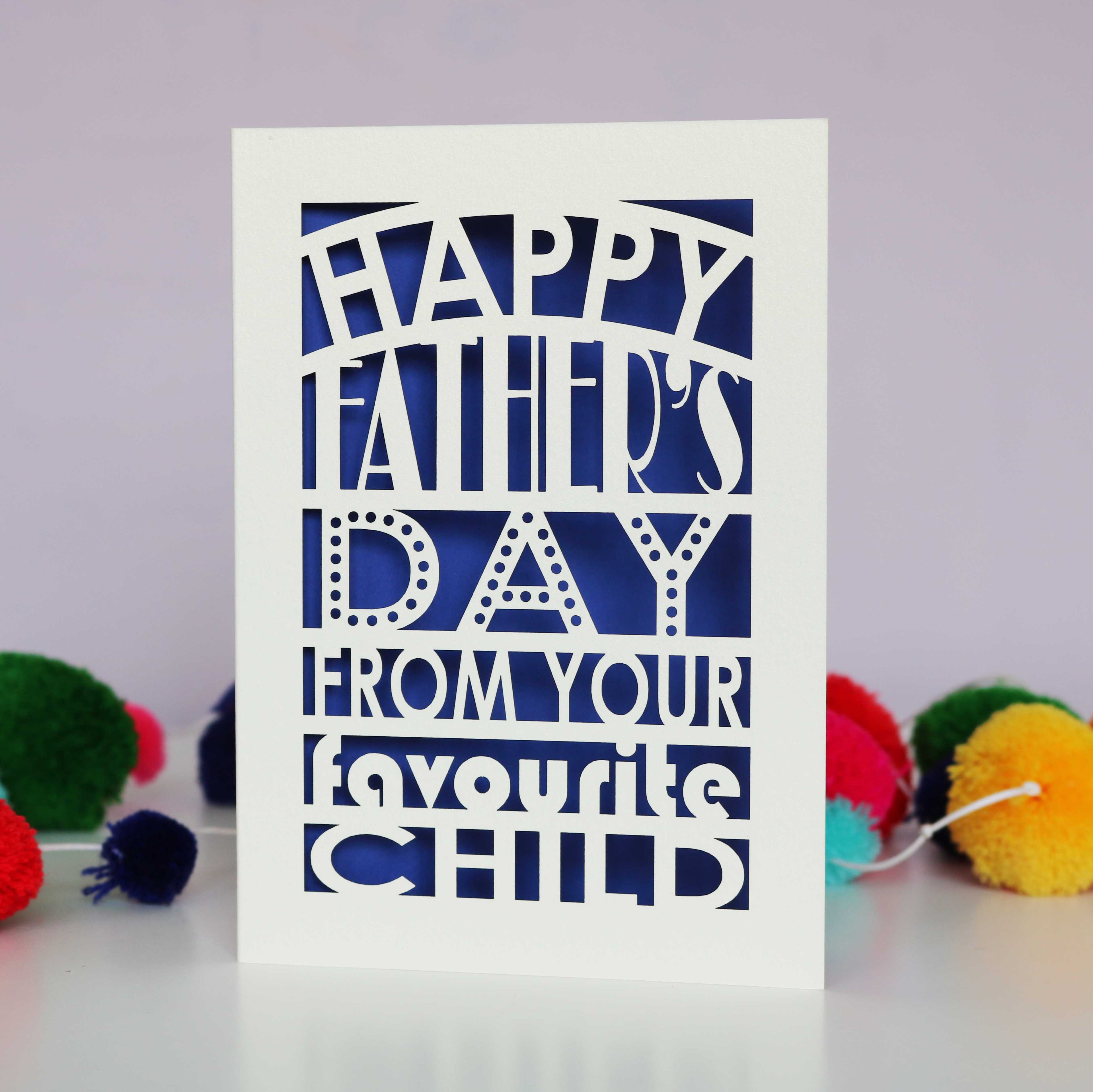 A laser cut fathers day card that says "Happy Father's Day from your favourite child"
