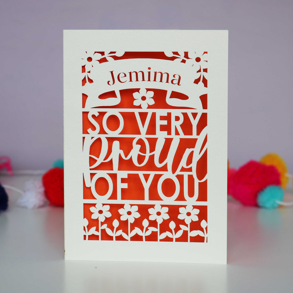 A laser cut graduation card that is personalised with a name and reads "So very proud of you"