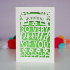 A laser cut exam congratulations card that is personalised with a name and reads "So very proud of you"
