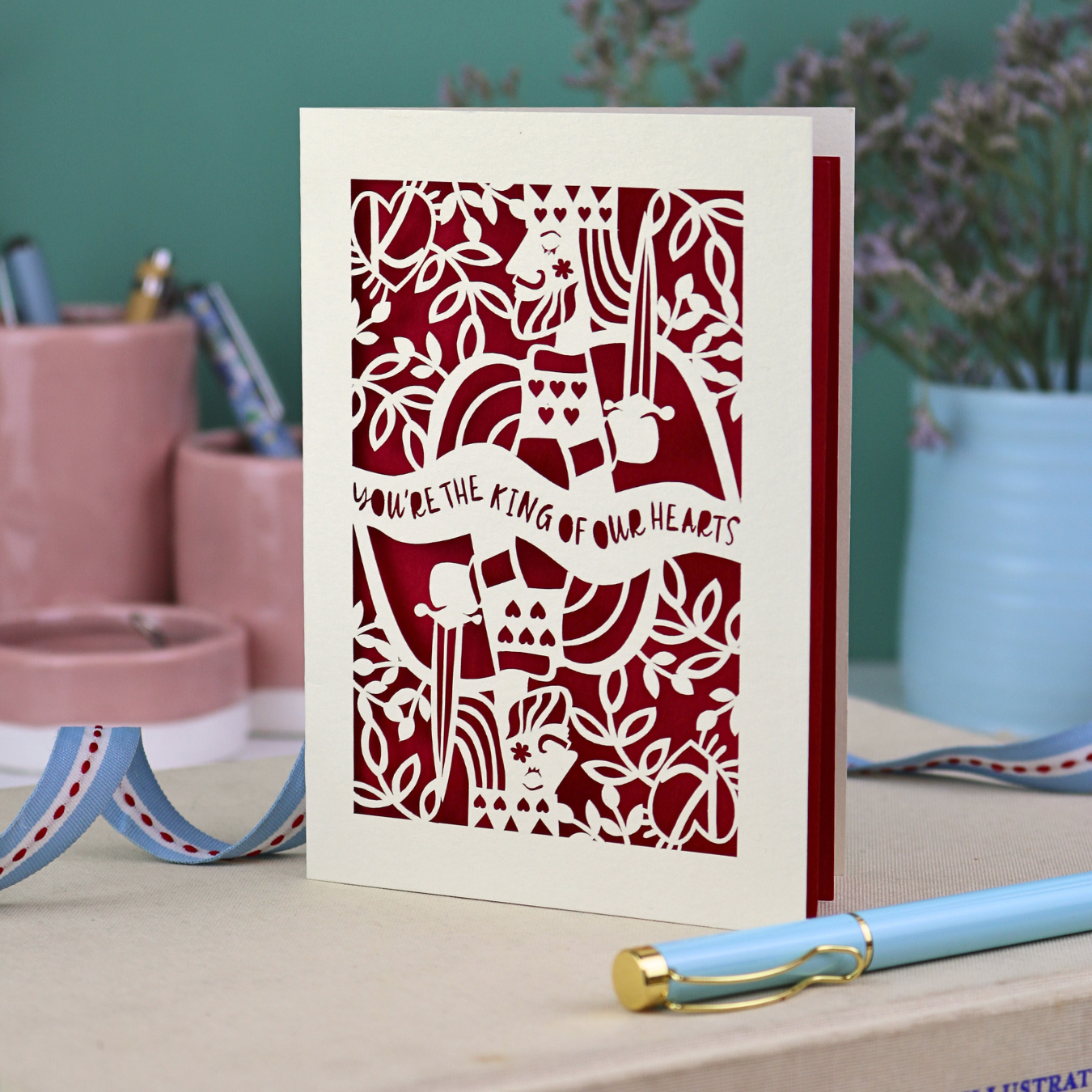 A laser cut Father's Day card with King of Hearts design and the text "You're the king of our hearts"