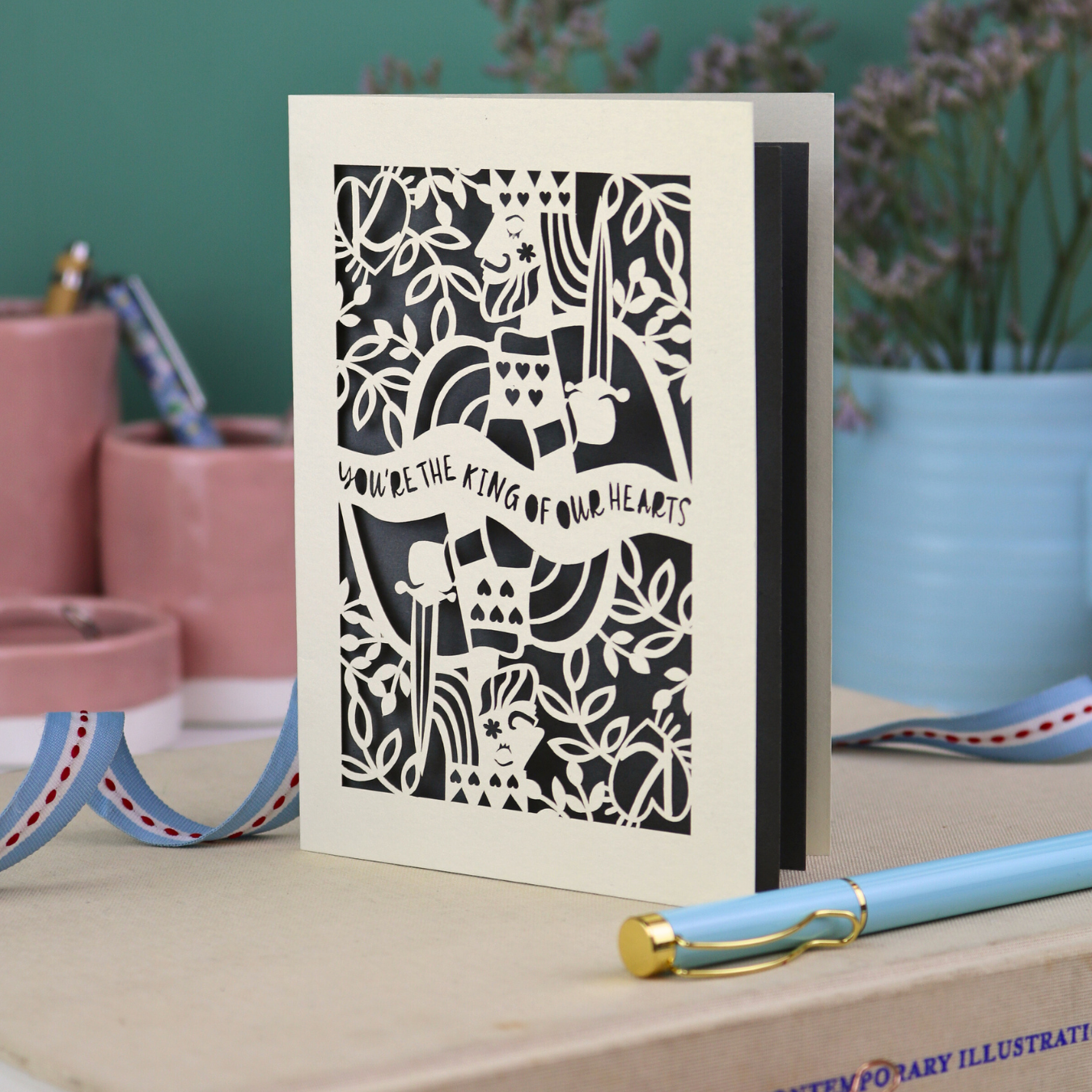 A laser cut Father's Day card with King of Hearts design and the text "You're the king of our hearts"