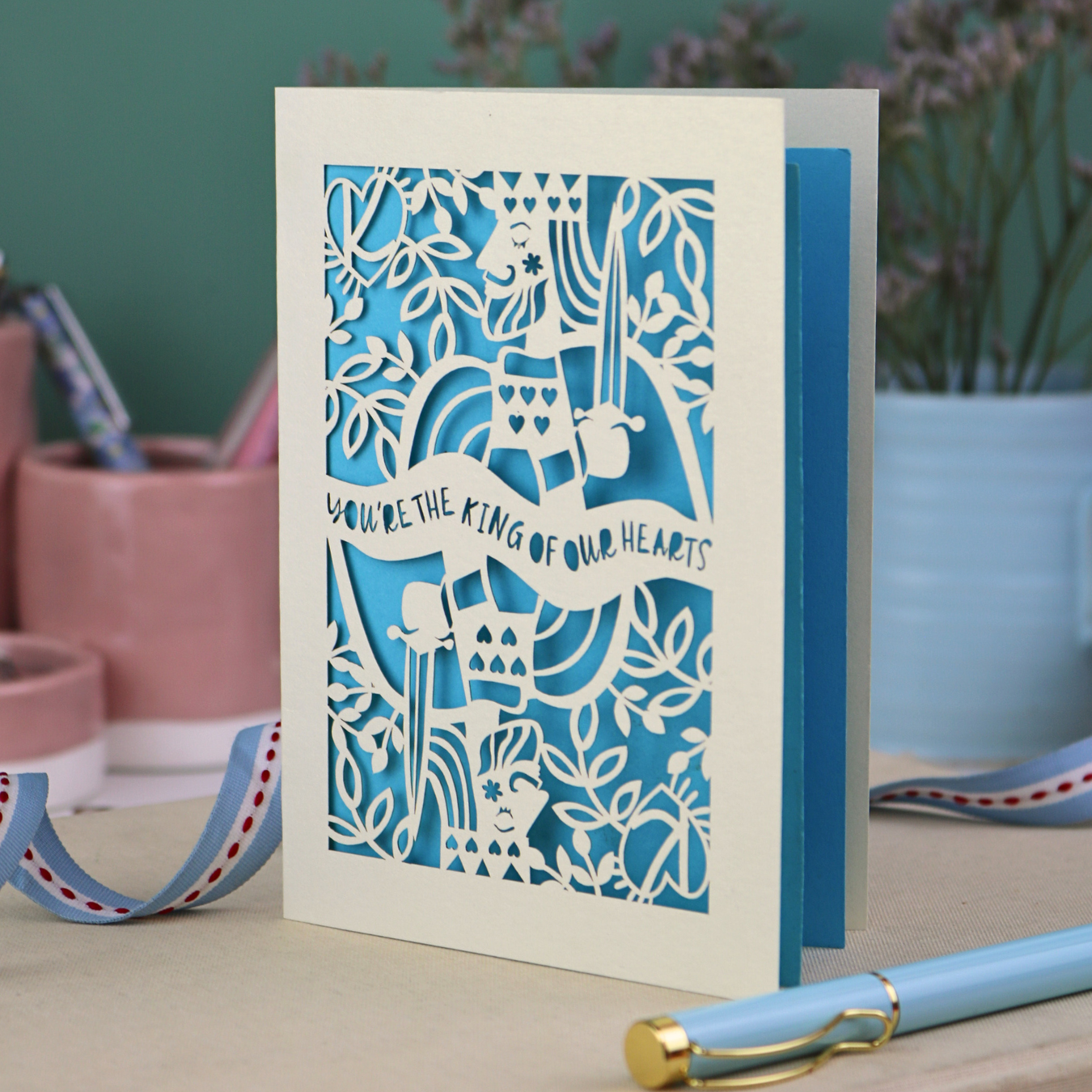 A laser cut Father's Day card with King of Hearts design and the text "You're the king of our hearts"