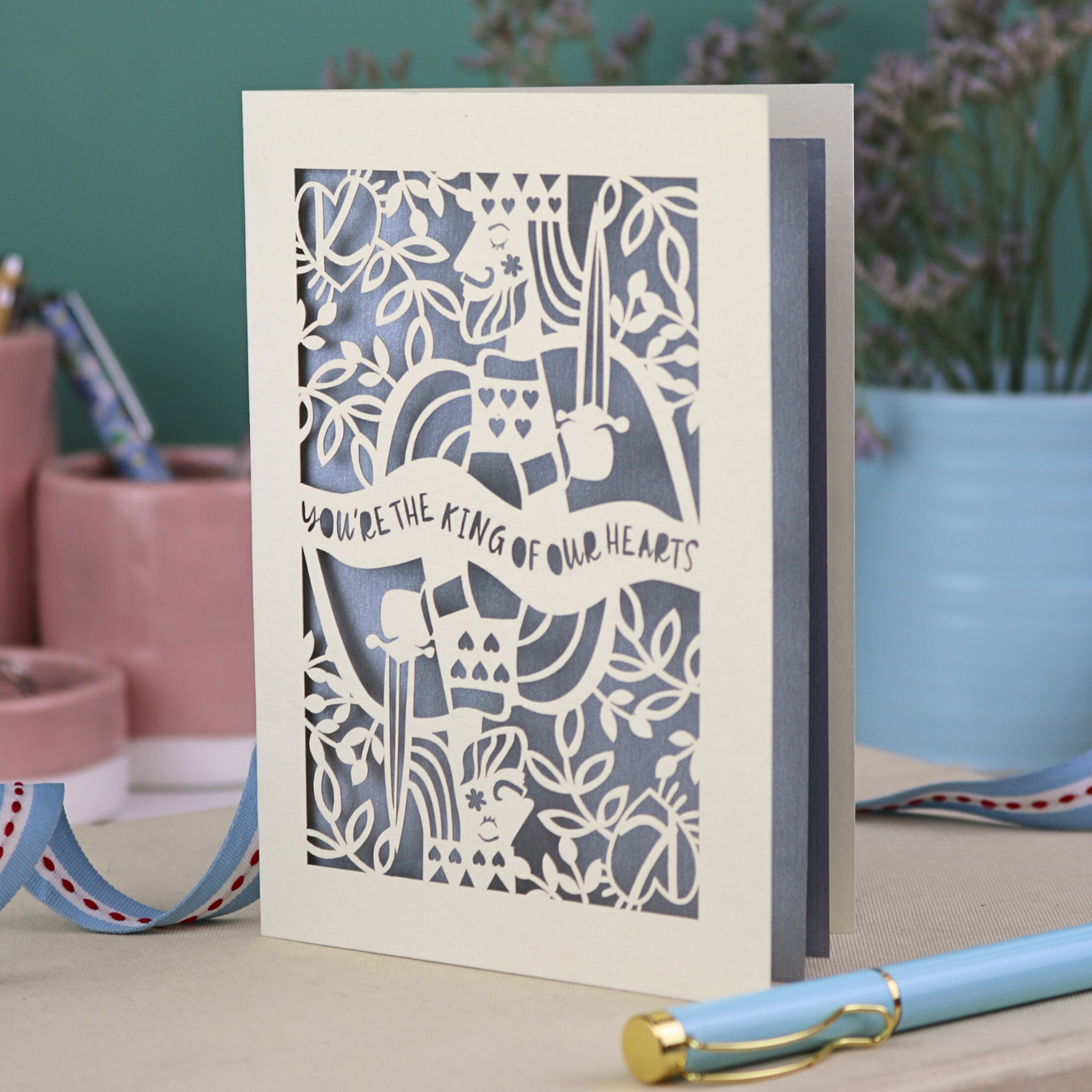 A laser cut Father's Day card with King of Hearts design and the text "You're the king of our hearts"