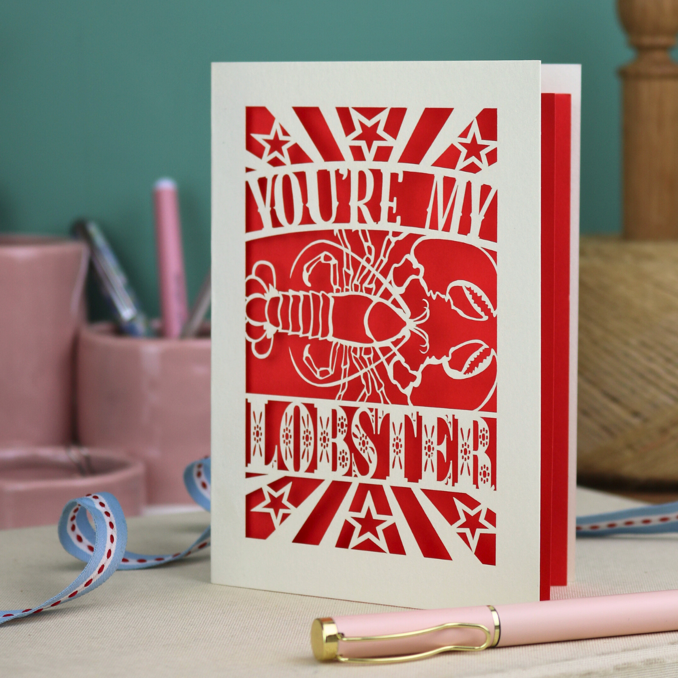 A laser cut Valentine's card with lobster design and text "You're My Lobster"