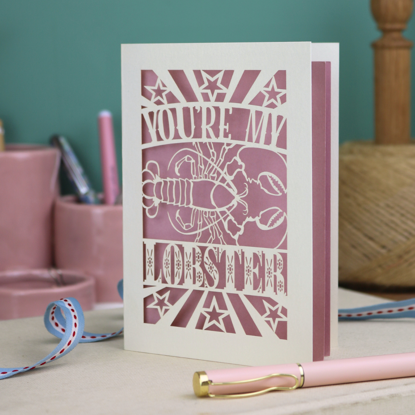 A laser cut Valentine's card with lobster design and text "You're My Lobster"
