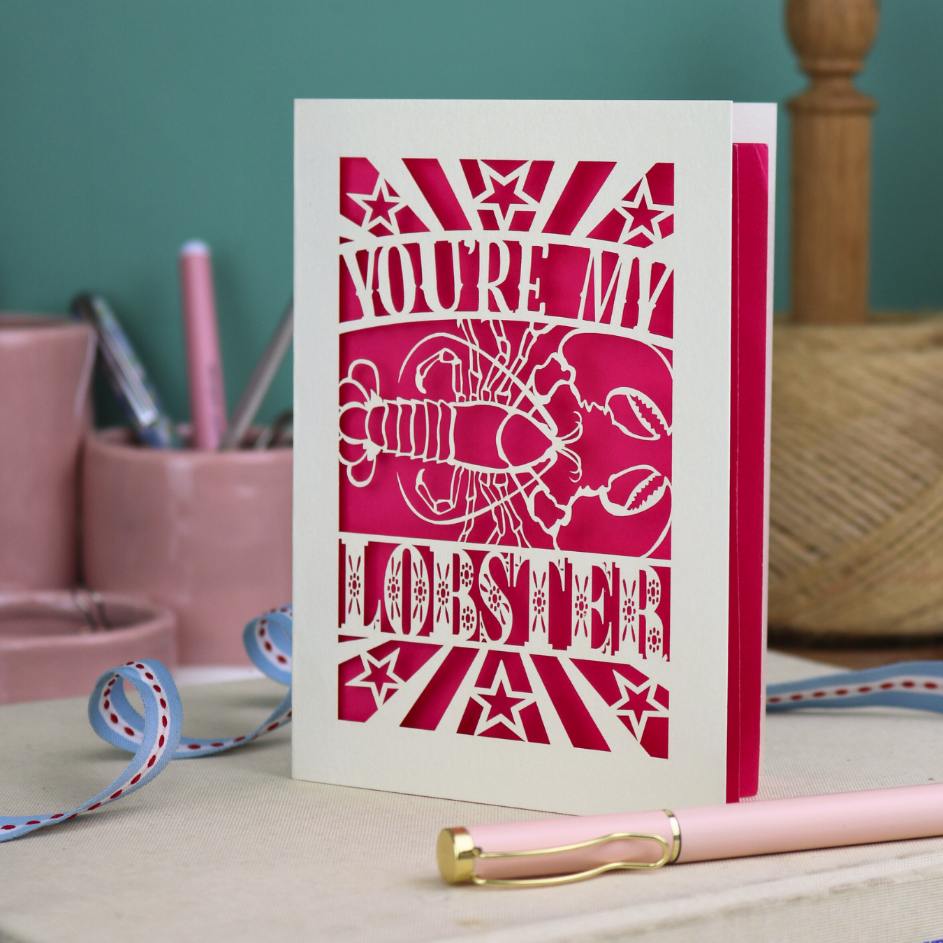 A laser cut Valentine's card with lobster design and text "You're My Lobster"