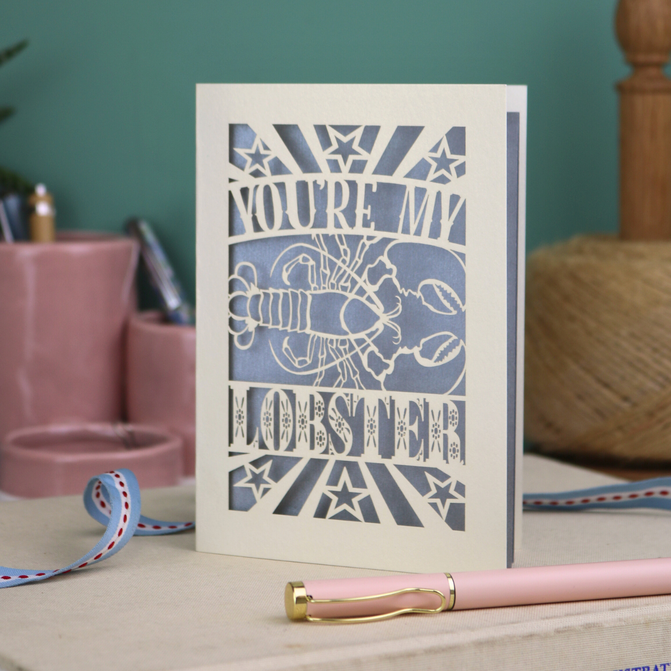 A laser cut Valentine's card with lobster design and text "You're My Lobster"