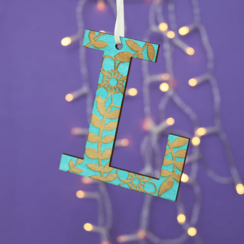 A teal, laser engraved wooden letter Christmas decoration - 