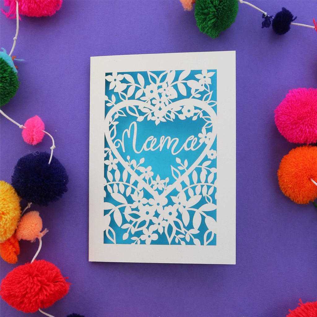 Laser cut Mother's Day card that says "Mama" inside a heart with flowers around it